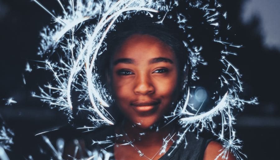 WOC smiling with sparkler