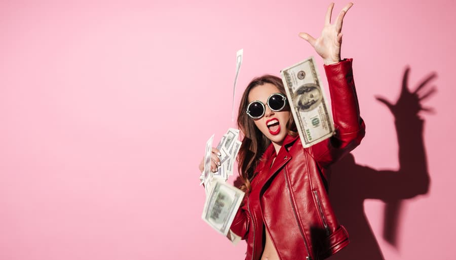 Girl throwing Money, pink background