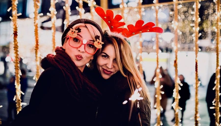 Two Female Friends Outside Celebrating Christmas