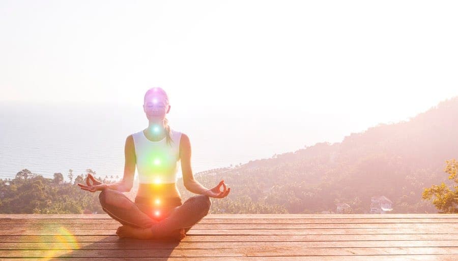 Woman chakra meditation on mountaintop