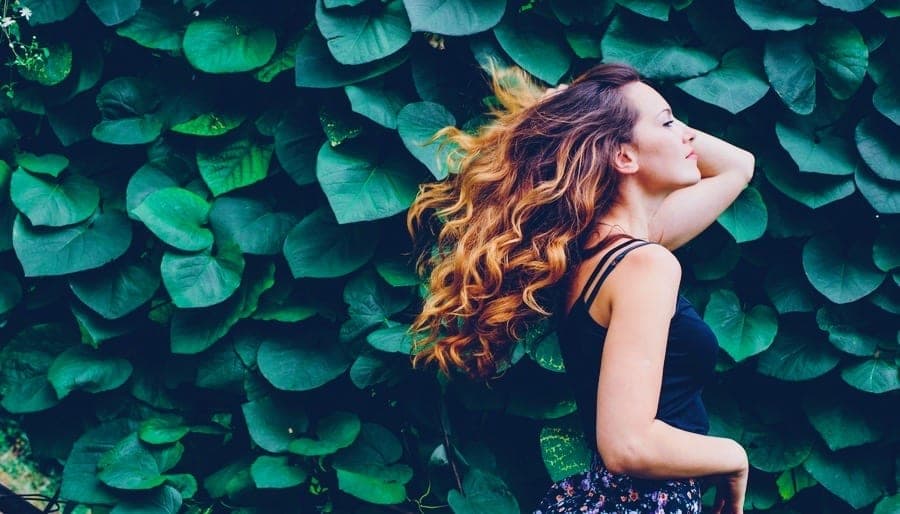 Woman and Leafy Green Wall