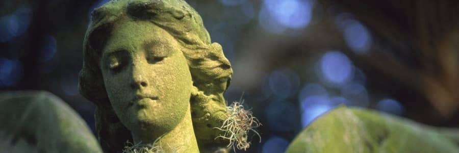 Green Mossy Face of Statue of Archangel Ariel