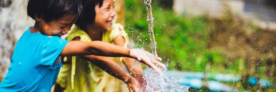 Children playing with water laughing
