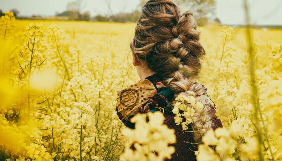 virgo woman in a field of yellow flowers