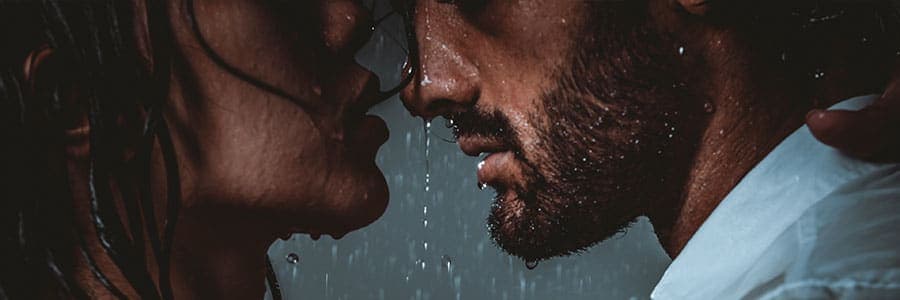 man and woman in rain during scorpio season