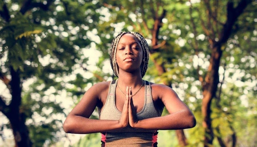 WOMAN OF COLOUR DOING YOGA
