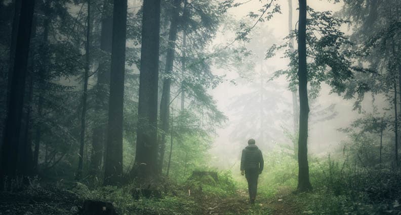 man walking in field