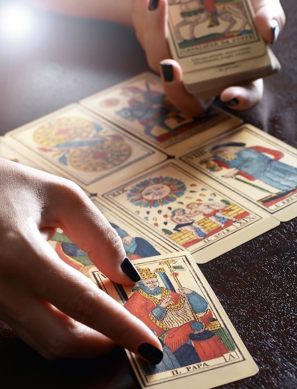 Tarot Card Reader Performing Reading