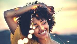 Woman Smiling with Fairy Lights