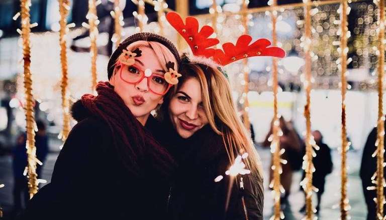 Two Female Friends Outside Celebrating Christmas