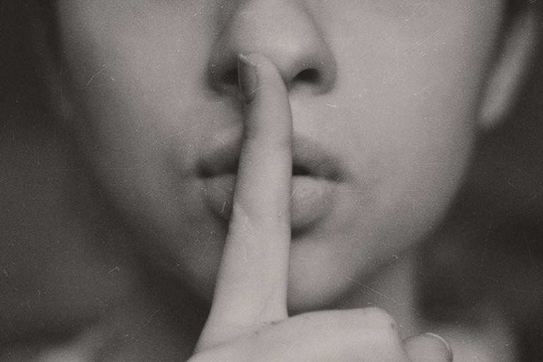 Shhh - Finger in Front of Lips Signalling Quiet.