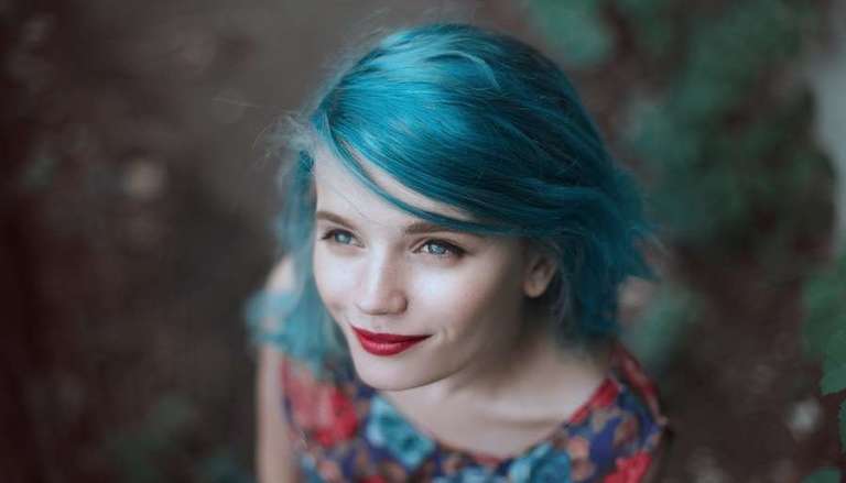 Girl looking up with blue hair & red lipstick