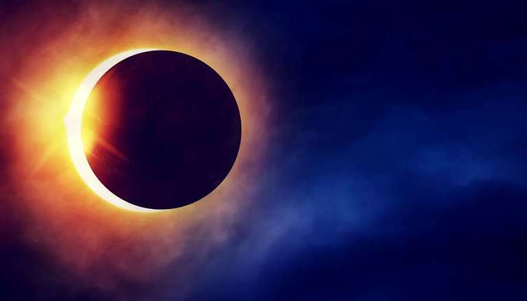 Partial Solar Eclipse on dramatic dark blue sky