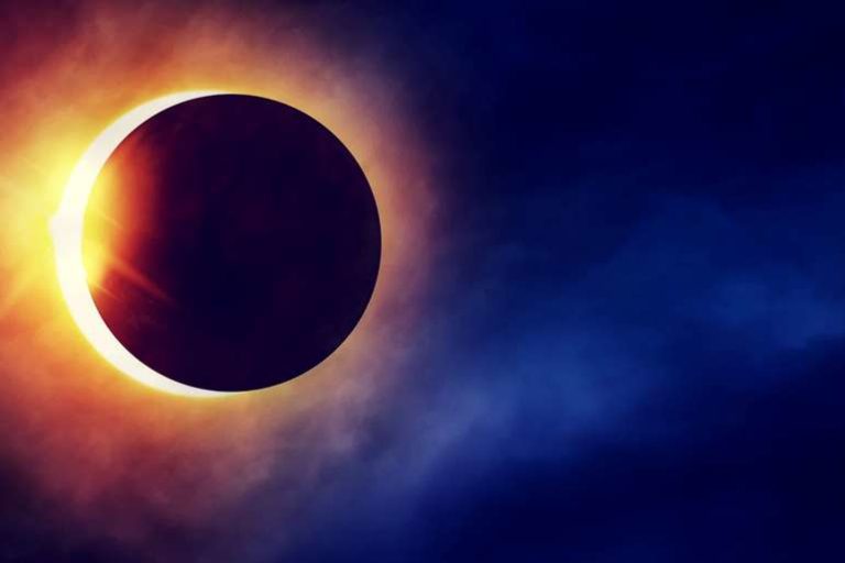Partial Solar Eclipse on dramatic dark blue sky