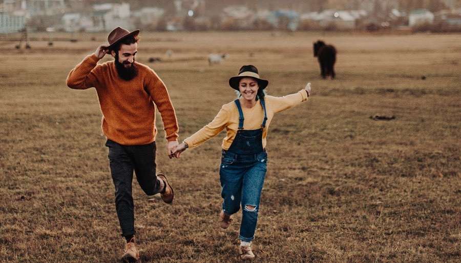 Couple Running Free at a Festival - Sagittarius Love